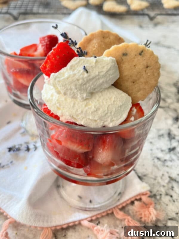 Lavender Shortbread and Lavender Strawberry Cream 5 A serving of lavender shortbread, whipped cream, and fresh strawberries infused with lavender syrup, artfully arranged on a dessert plate.