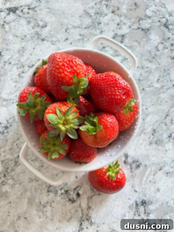Lavender Shortbread and Lavender Strawberry Cream 8 A bowl of fresh, vibrant red strawberries with green caps, ready to be prepared.