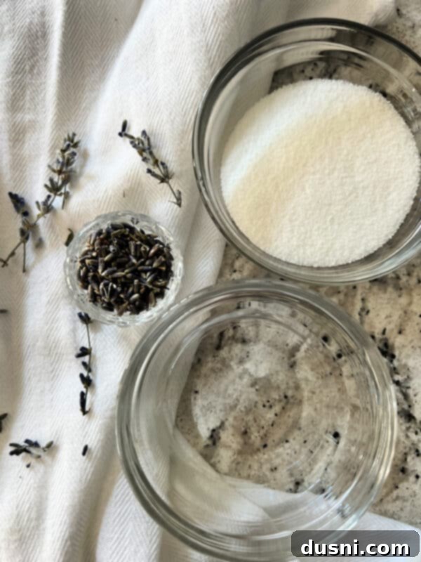 Lavender Shortbread and Lavender Strawberry Cream 9 A small glass jar filled with homemade lavender simple syrup, with fresh lavender sprigs in the background.