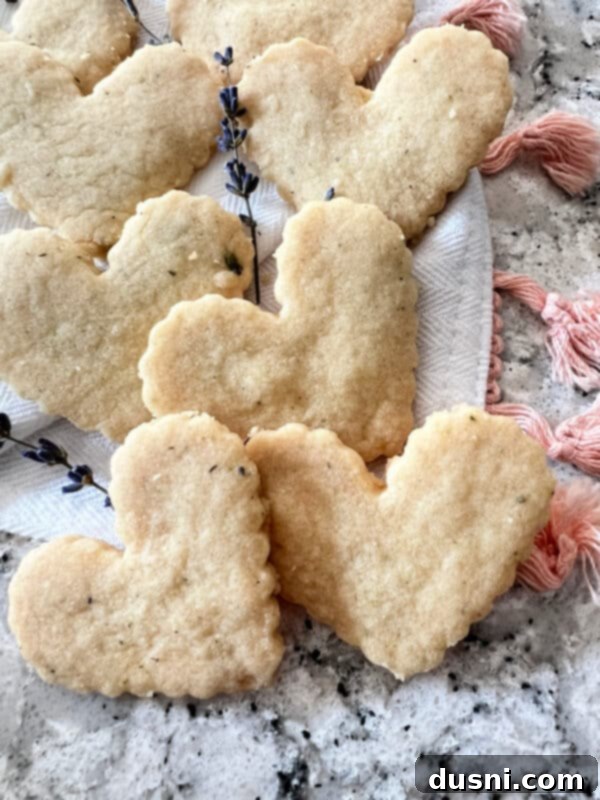 Lavender Shortbread and Lavender Strawberry Cream 10 Heart-shaped lavender shortbread cookies cooling on a wire rack with a rustic linen underneath.