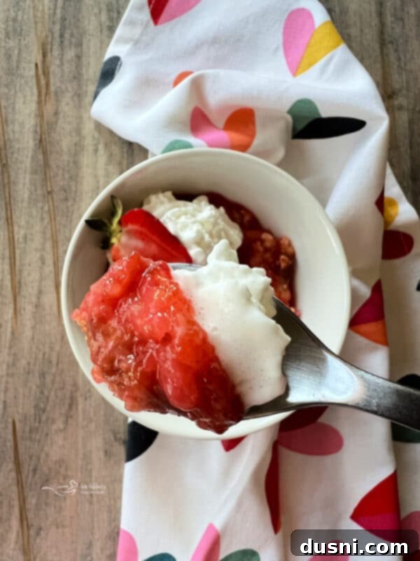 Strawberry Rhubarb Bliss 14 A spoonful of Strawberry Rhubarb Cobbler with whipped cream