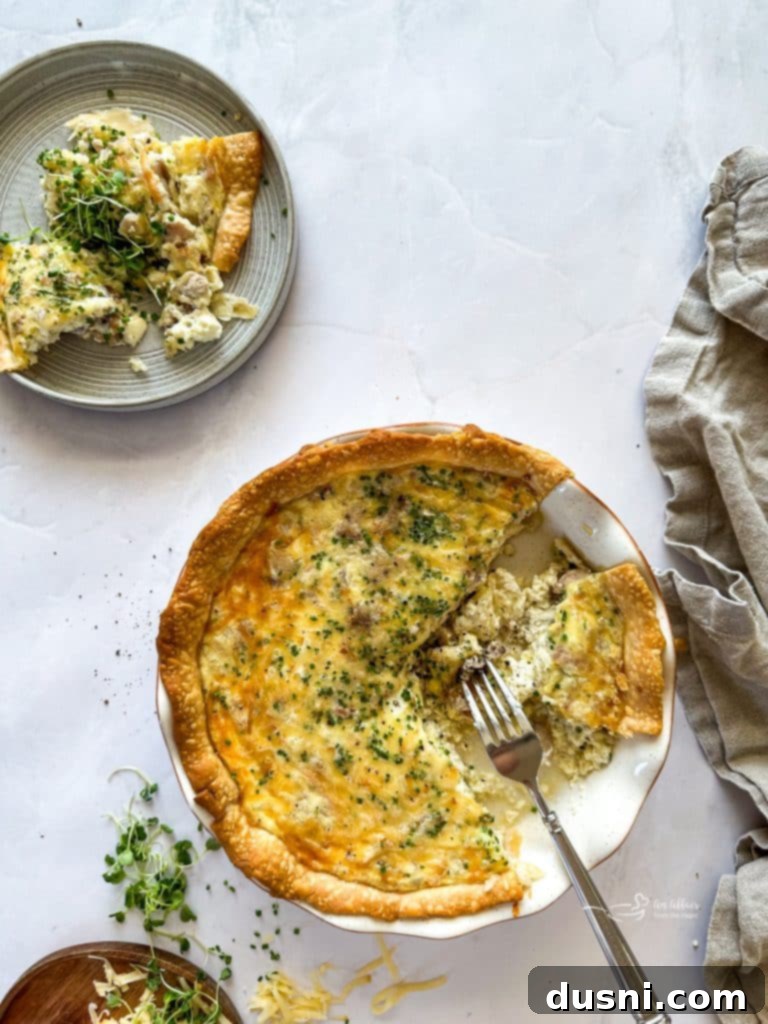 Savory Ham and Smoked Gouda Quiche 2 Delicious slice of Smoked Ham & Gouda Quiche on a plate, ready to be served.