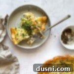 Savory Ham and Smoked Gouda Quiche 16 Two slices of Ham and Smoked Gouda quiche on a gray plate.