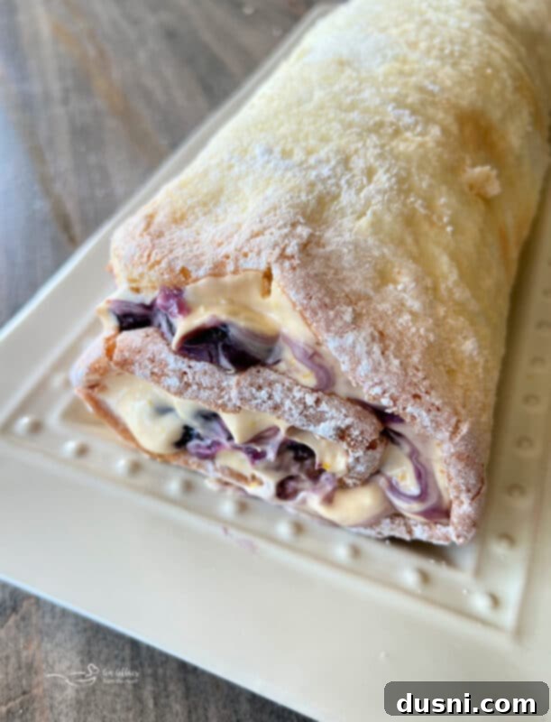 Blueberry Orange Cloud Roll 15 Spreading cream cheese and blueberry pie filling onto the unrolled angel food cake.