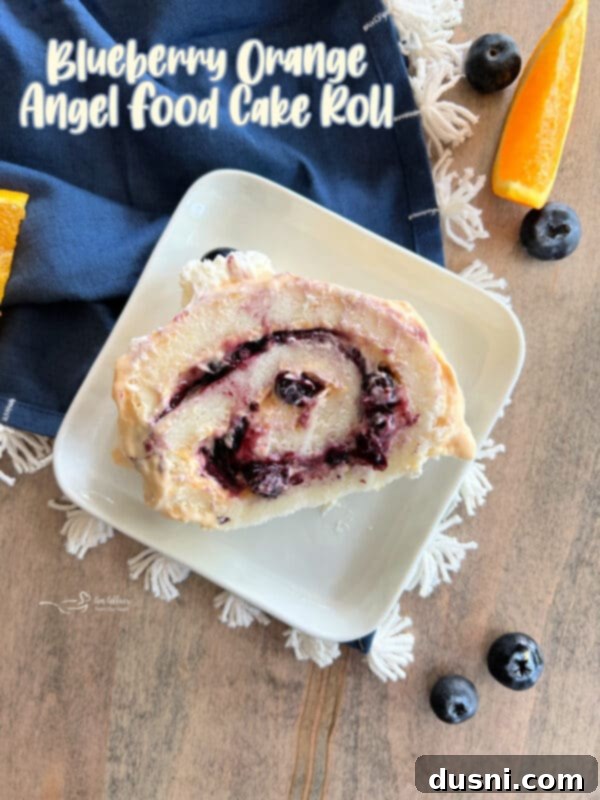 Blueberry Orange Cloud Roll 20 Hero shot of the garnished Blueberry Orange Angel Food Cake Roll.
