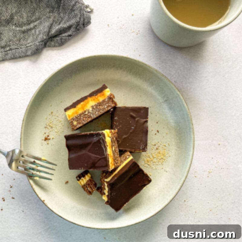 No-Bake Classic Nanaimo Bars 16 A large tray of Nanaimo bars, some whole, some partially sliced