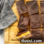 No-Bake Classic Nanaimo Bars 21 Nanaimo Bars sliced on a wooden platter