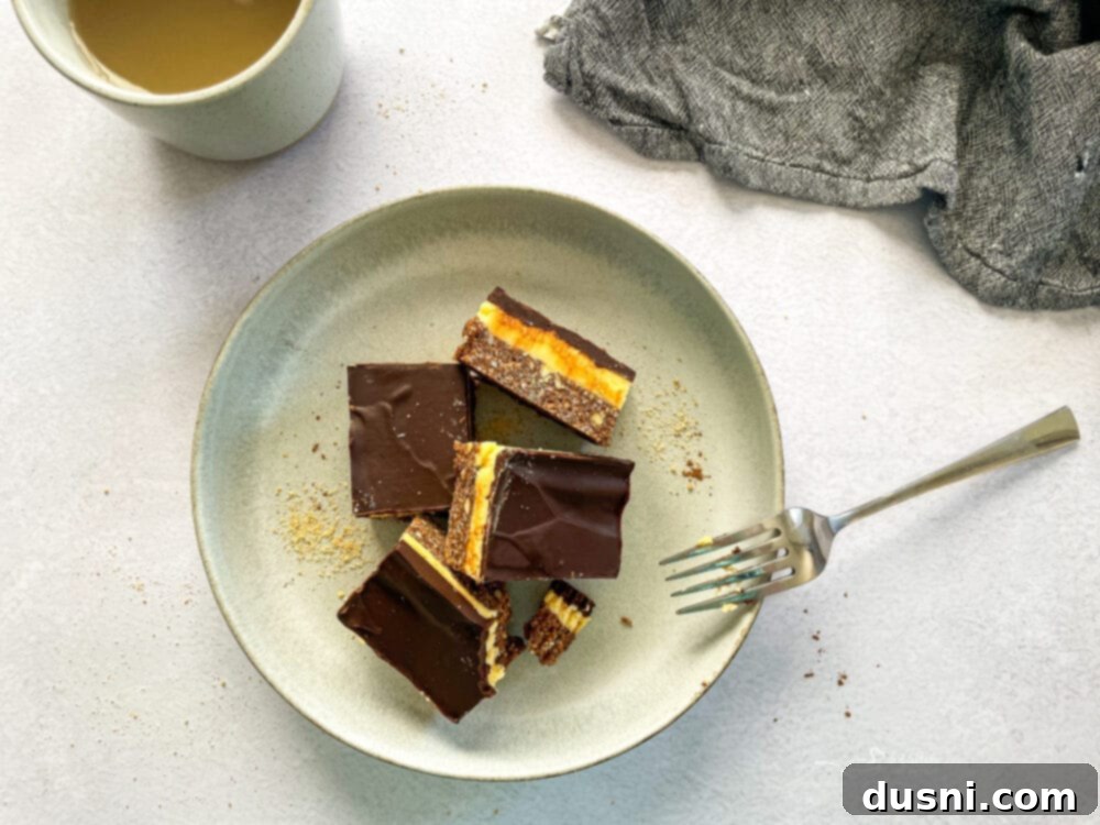 No-Bake Classic Nanaimo Bars 4 Various Nanaimo bar squares arranged on a wooden board