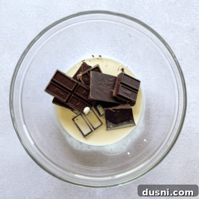 No-Bake Classic Nanaimo Bars 7 A tray of Nanaimo bars with the middle custard layer applied over the base