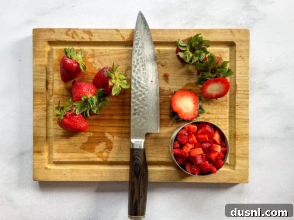 Freshly sliced strawberries, ready for baking in homemade quick bread.