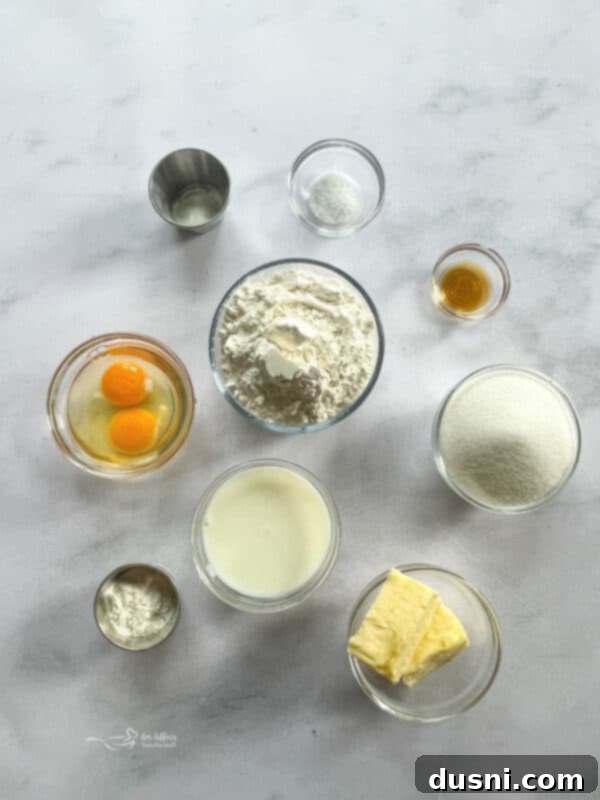 A bowl of fresh ingredients for strawberry bread including flour, sugar, butter, and eggs.