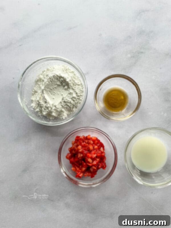 Ingredients for making a strawberry glaze: powdered sugar, vanilla, milk, and fresh strawberries.