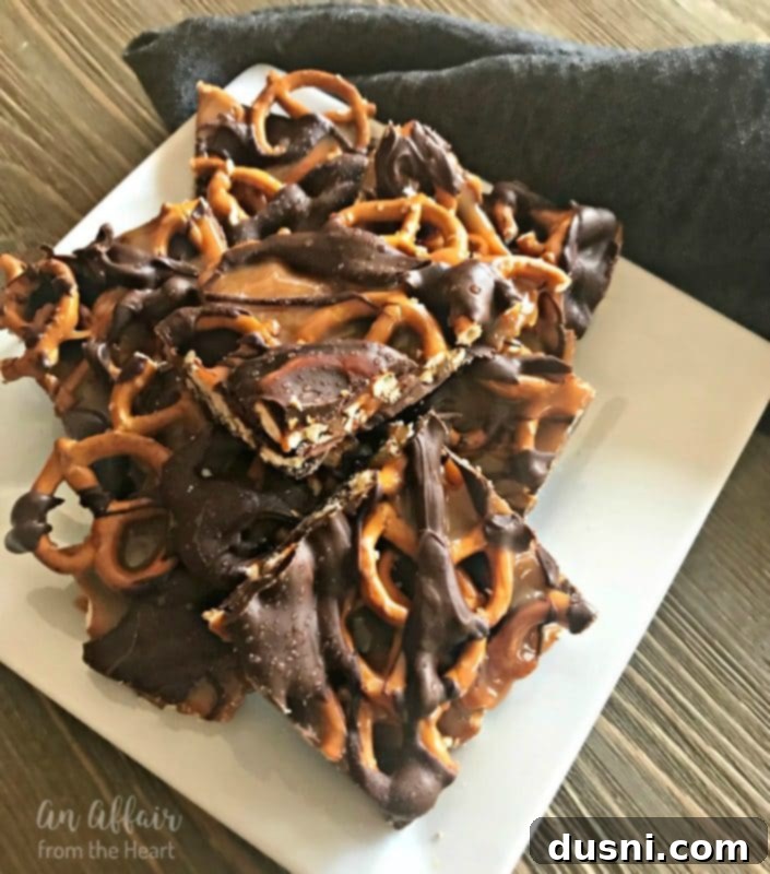 Salted Caramel Chocolate Pretzel Bars stacked on a white plate