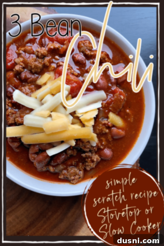 A vibrant close-up of a bowl of Three Bean Chili with various toppings, emphasizing the rich color and inviting texture of the dish.