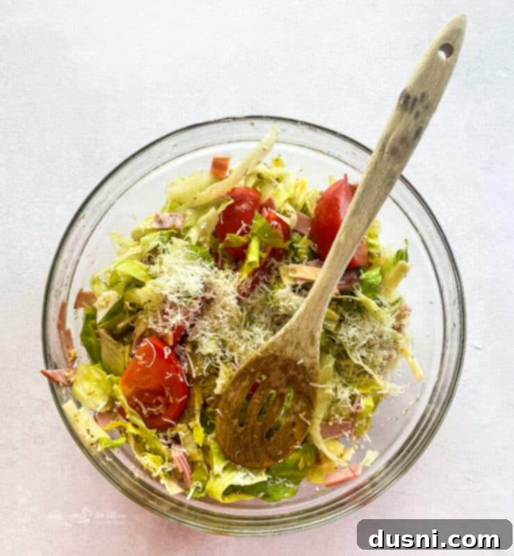 Columbia Restaurant's 1905 Salad 11 Dressing the 1905 Salad in a large bowl.