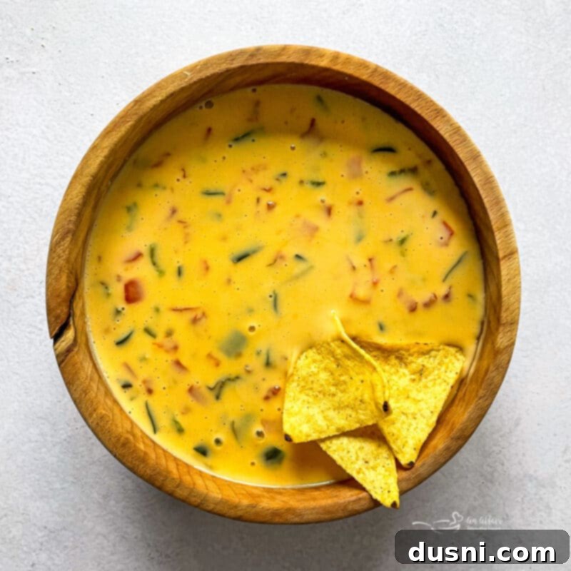 Homemade Qdoba Queso 3 Chips Dipped in Cheese Sauce