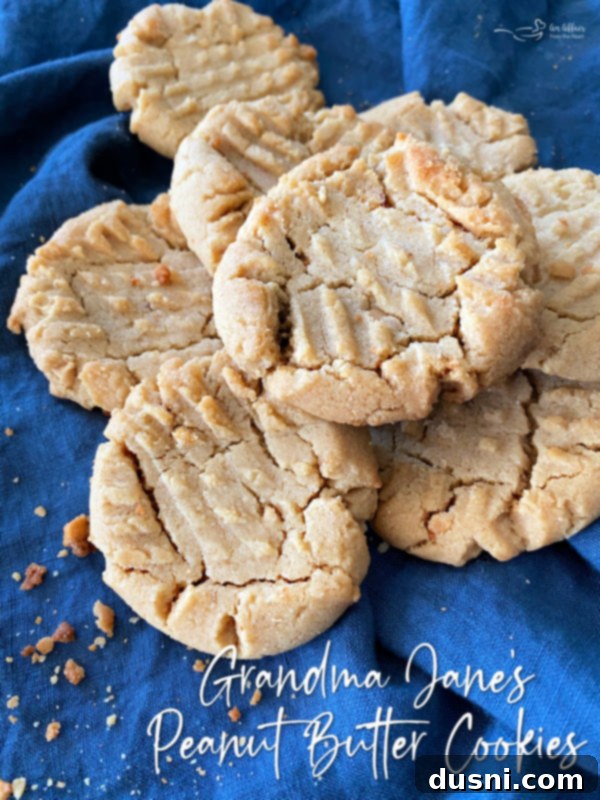 top view of a stack of classic peanut butter cookies with text overlay: 'Grandma Jane's Peanut Butter Cookies'