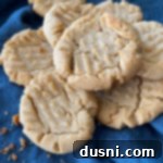 mom's homemade peanut butter cookie recipe on blue linen background