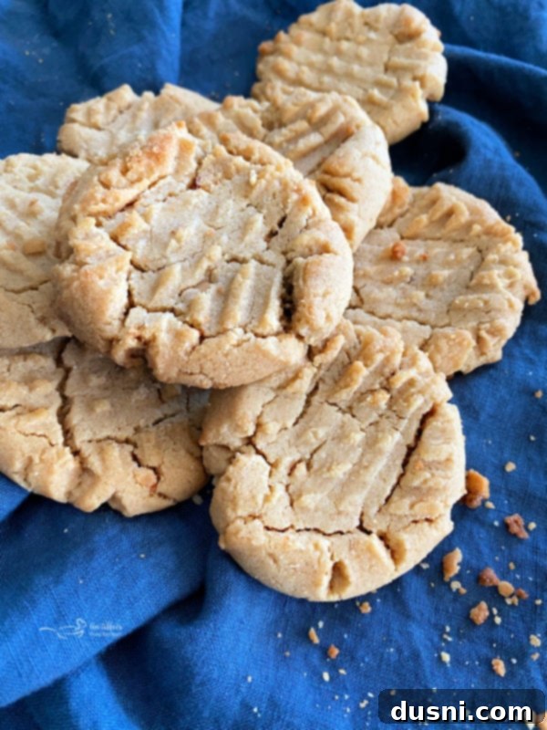a stack of homemade peanut butter cookies with perfect fork marks