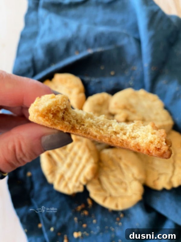 close-up view of a perfectly baked, soft peanut butter cookie with a bite taken out