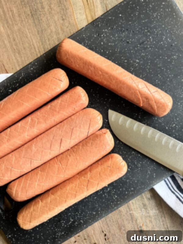 Smoky Franks with Tangy Kraut 11 Close-up of scoring a hot dog with a knife