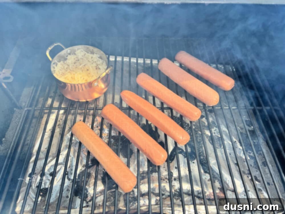 Smoky Franks with Tangy Kraut 12 Smoked hot dogs and a dish of kraut on a pellet grill rack