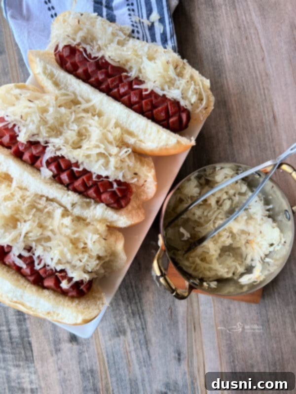Smoky Franks with Tangy Kraut 3 Close-up of a smoked hot dog in a bun with sauerkraut and caraway seeds