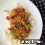 Slow Cooker Chicken Teriyaki on rice on a white plate