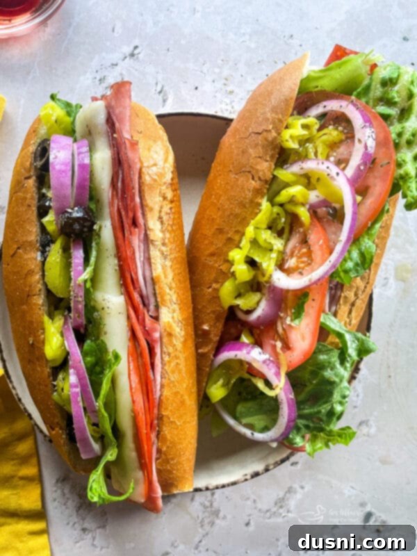 Delicious Toasted Italian Sub Sandwiches filled with ham, salami, pepperoni, melted cheese, and fresh vegetables.