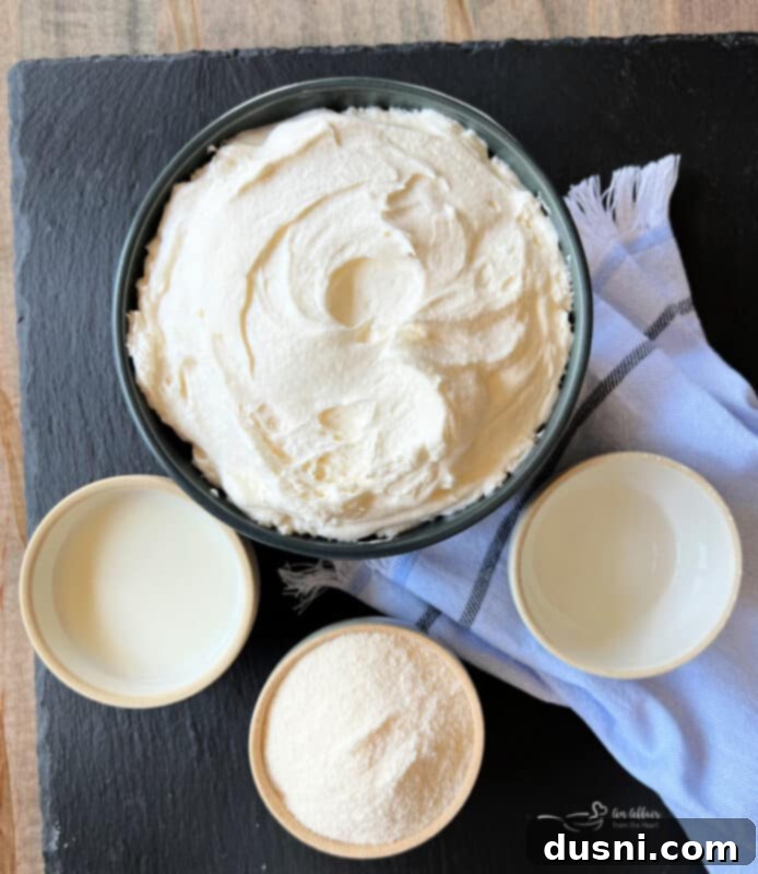 Overhead view of a small bowl filled with creamy vanilla almond fruit dip, showcasing its smooth texture and light color.