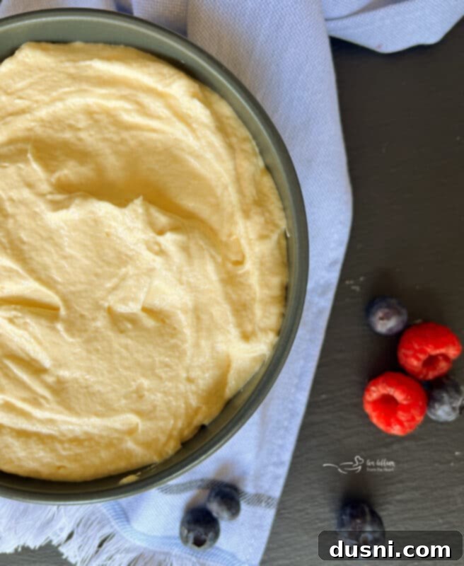 Ingredients laid out on a kitchen counter: a box of Jell-O vanilla pudding, a container of Cool Whip, a bottle of milk, and a bottle of almond extract.