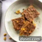 No Bake Chocolate Peanut Butter Cookie bars stacked on a cream colored plate.