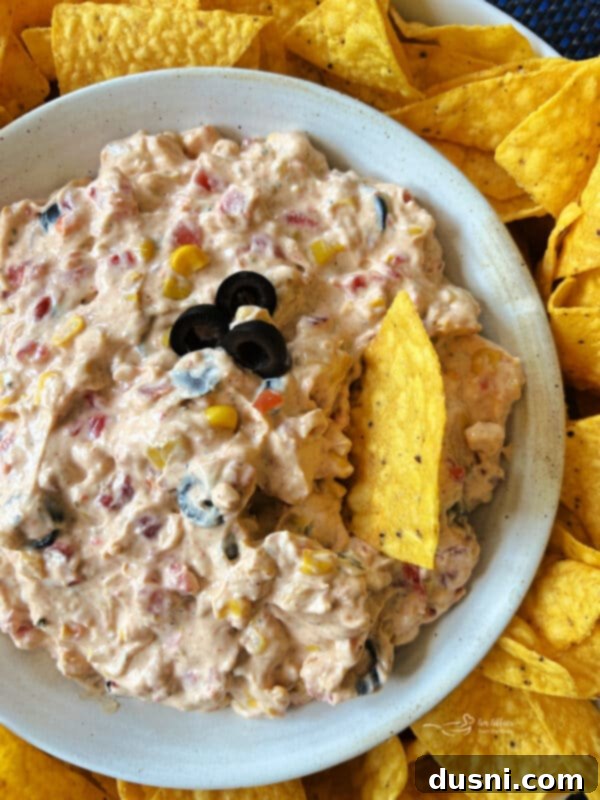 Easy 5 Ingredient Fiesta Corn Dip 12 Fiesta Corn Dip in a simple white bowl, ready to serve, with a focus on the dip's creamy texture.
