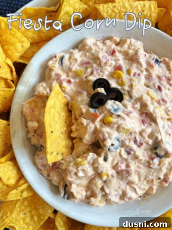 Easy 5 Ingredient Fiesta Corn Dip 14 A beautifully presented bowl of creamy Fiesta Corn Dip, garnished and ready for serving.