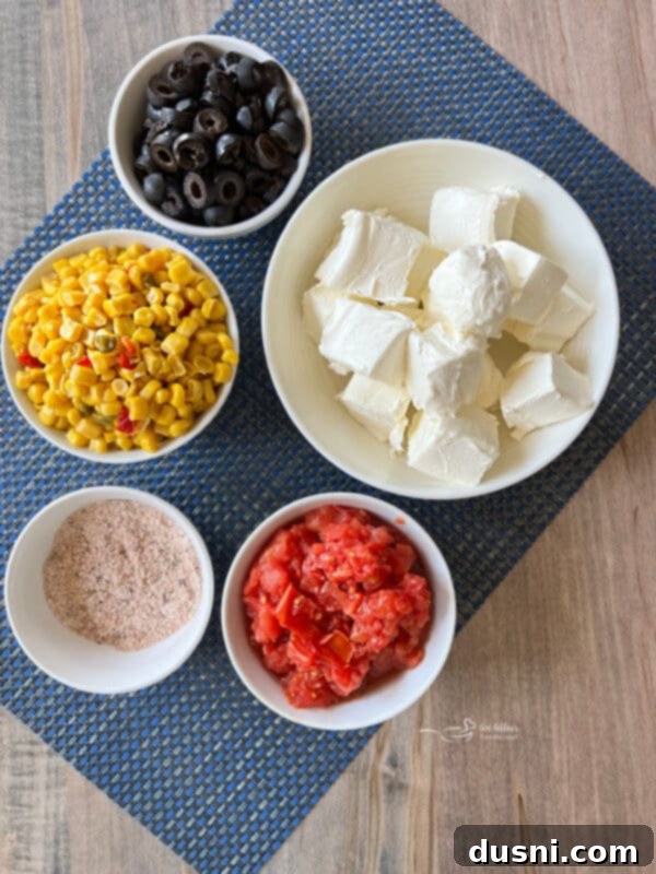 Easy 5 Ingredient Fiesta Corn Dip 3 Close-up of creamy Fiesta Corn Dip garnished with a few black olive slices.