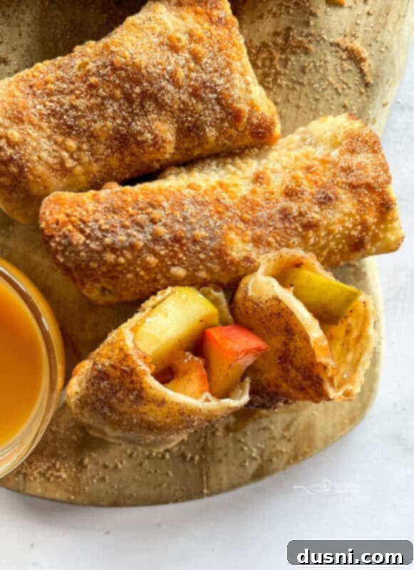 Air Fried Apple Pie Egg Rolls 4 Air Fryer Apple Pie Egg Rolls cooking in an air fryer basket