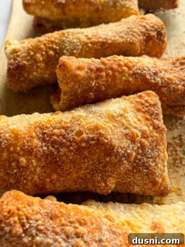 Air Fried Apple Pie Egg Rolls 9 Air Fryer Apple Pie Egg Rolls arranged in a single layer in the air fryer basket