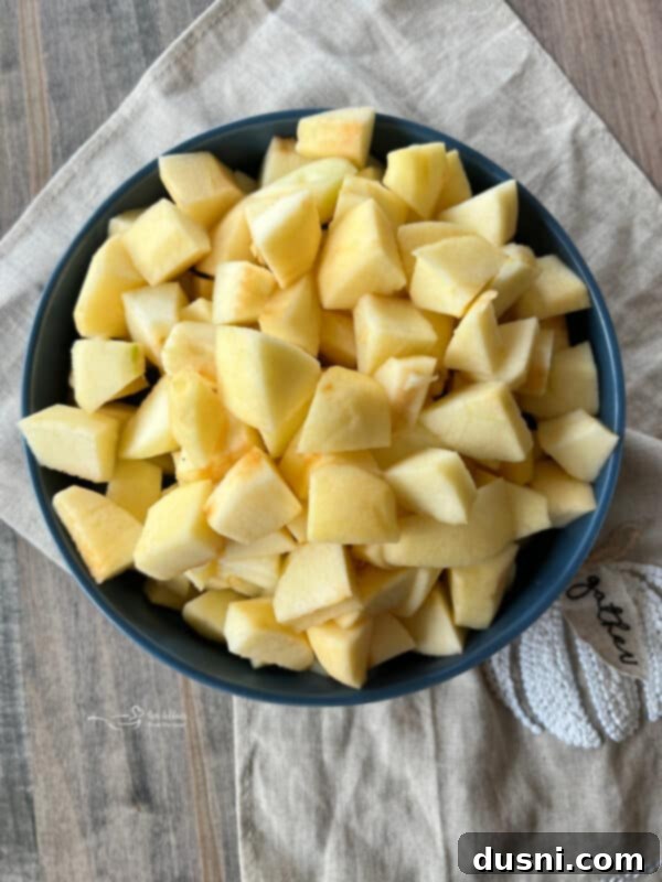 Step one of making Instant Pot Pumpkin Applesauce: Washing, peeling, and coring apples.