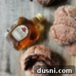 Vanilla Crown Royal Cookies and a small bottle of vanilla crown royal on a wood surface.