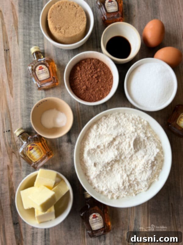 A plate of freshly baked Vanilla Crown Royal Cookies with a small bottle of Crown Royal Vanilla