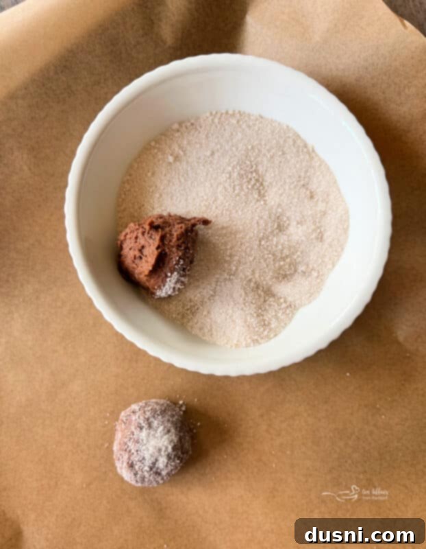 Scooping cookie dough for Vanilla Crown Royal Cookies