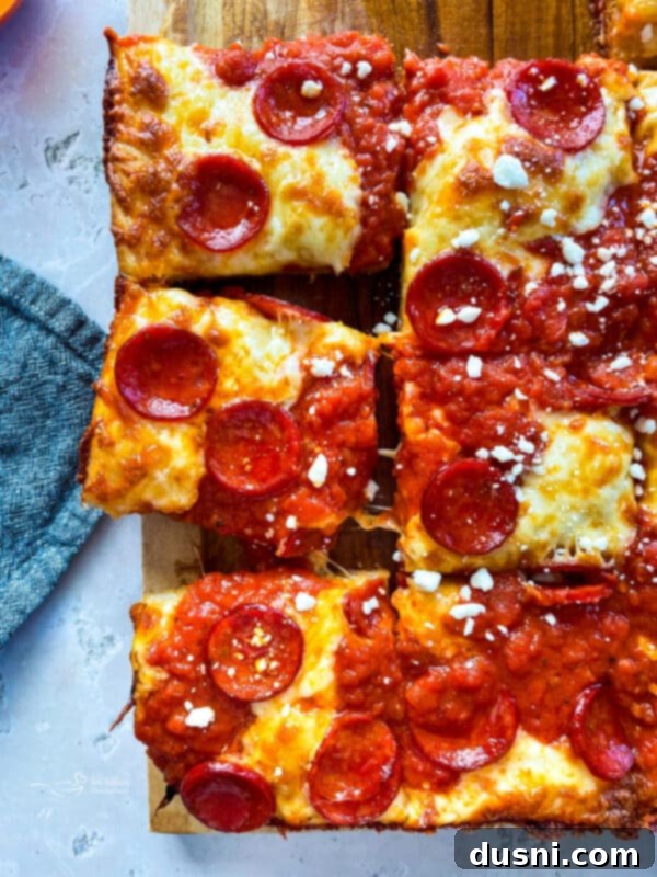 Homemade Detroit Style Pizza Perfection 2 Classic Detroit Style Pizza in a blue steel pan, sliced into squares.