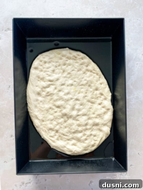 Homemade Detroit Style Pizza Perfection 10 Greasing a blue steel pan for Detroit Style Pizza.