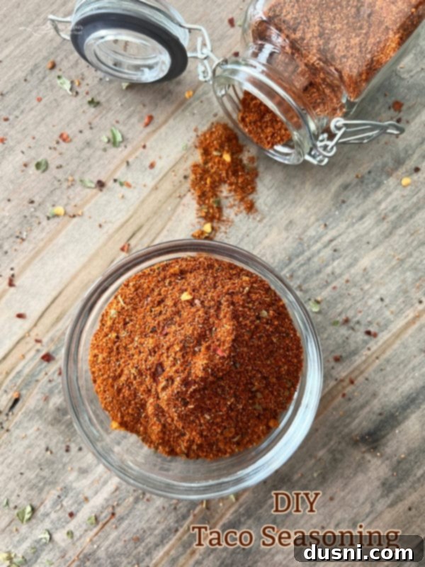 Do It Yourself homemade taco seasoning in a jar on a rustic wooden surface