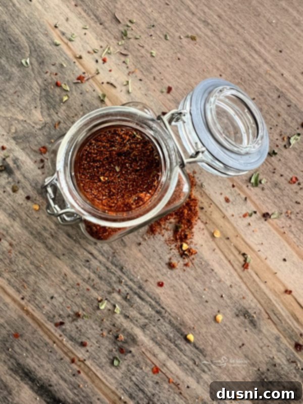 Homemade taco seasoning in a glass bowl with a spoon