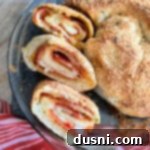 Sliced pepperoni pizza bread layered in a clear pie dish.