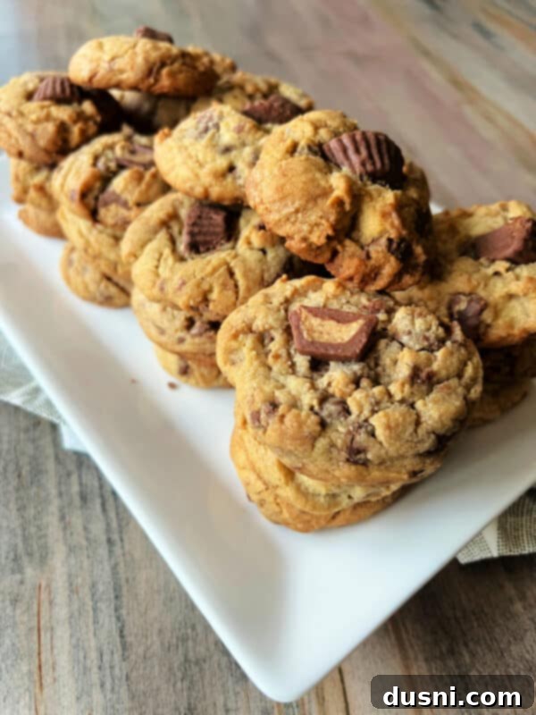 Ultimate Reese's Peanut Butter Cookies 4 Close-up of cookie dough mixed with miniature Reese's Peanut Butter Cups, ready for baking.