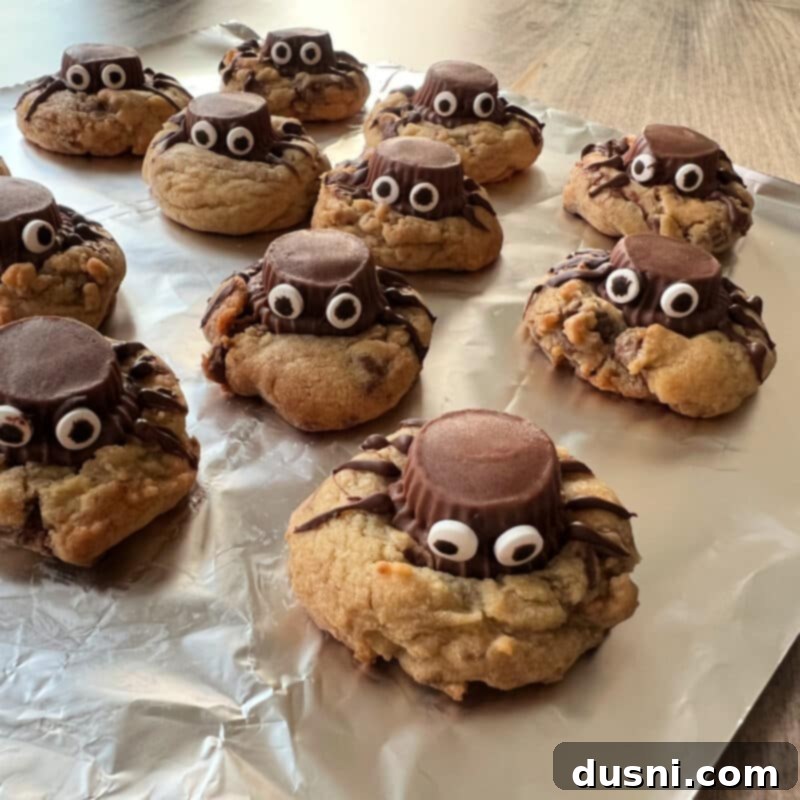 Pressing a Reese's Peanut Butter Cup with eyeballs into a warm cookie