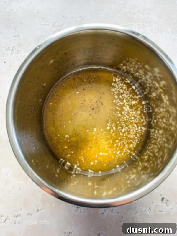 Pouring chicken stock into the Instant Pot.