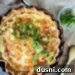 Overhead of bacon & swiss quiche in a pie dish, ready to be served